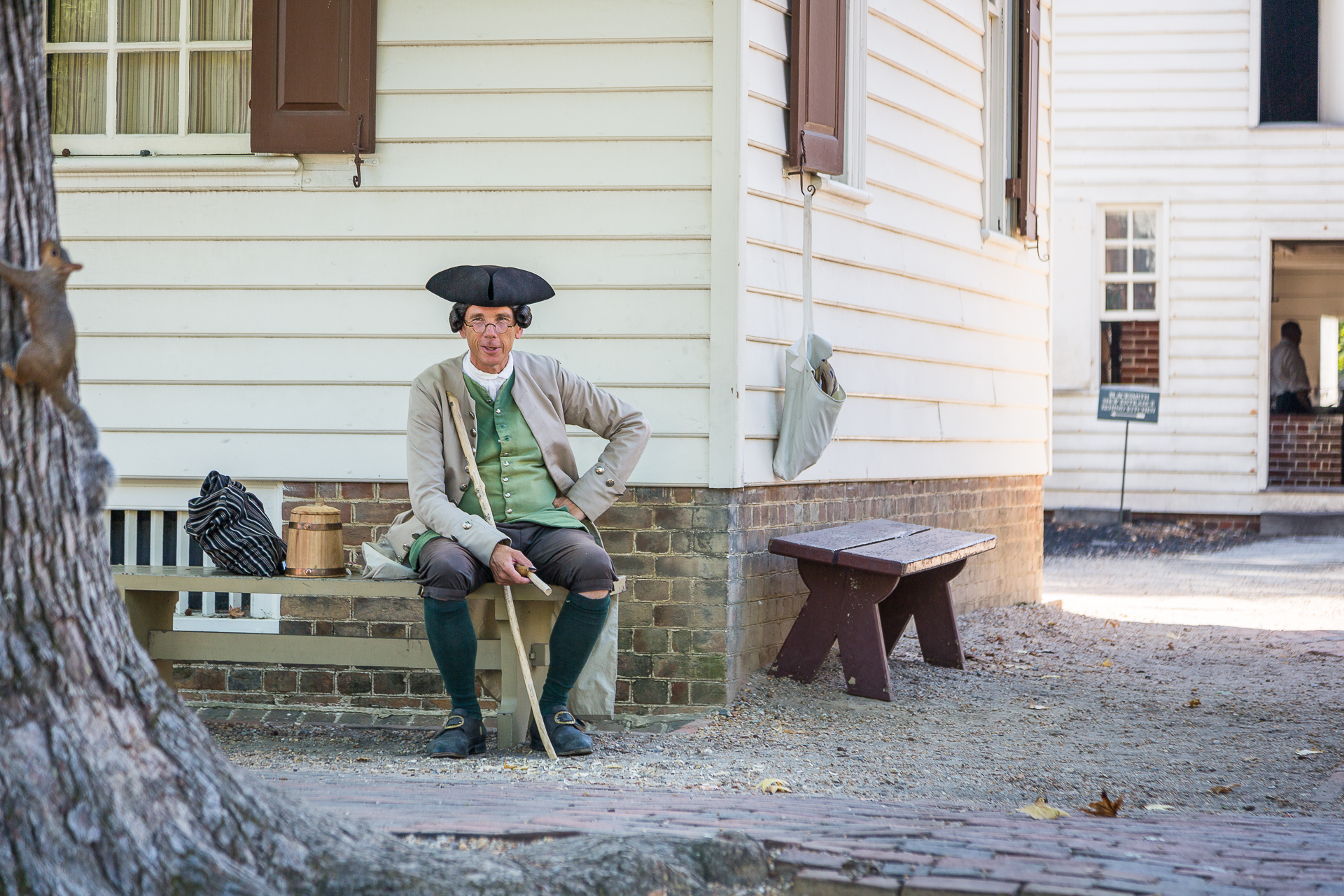 A gentleman in colonial clothing, relaxing in Colonial Williamsburg.