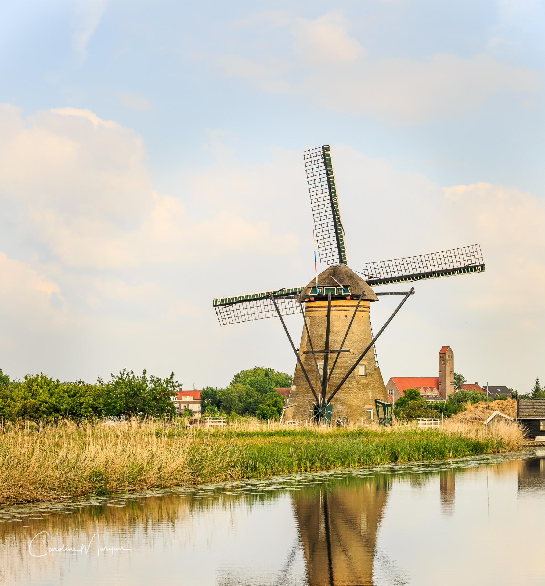 An old windwill along a canal in Kinderdijk, Netherlands.