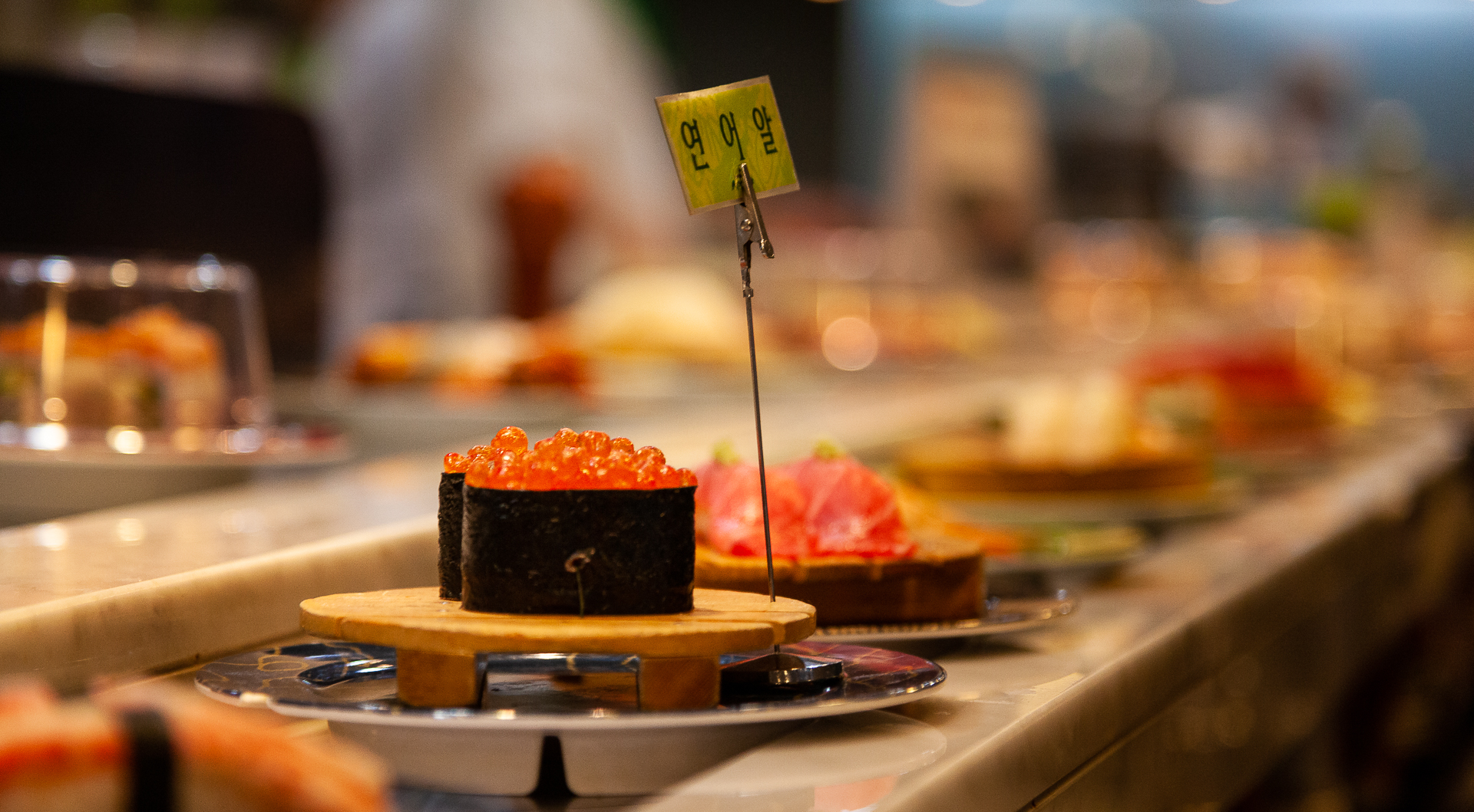 Panorama of Sushi at a Korean conveyor belt sushi bar