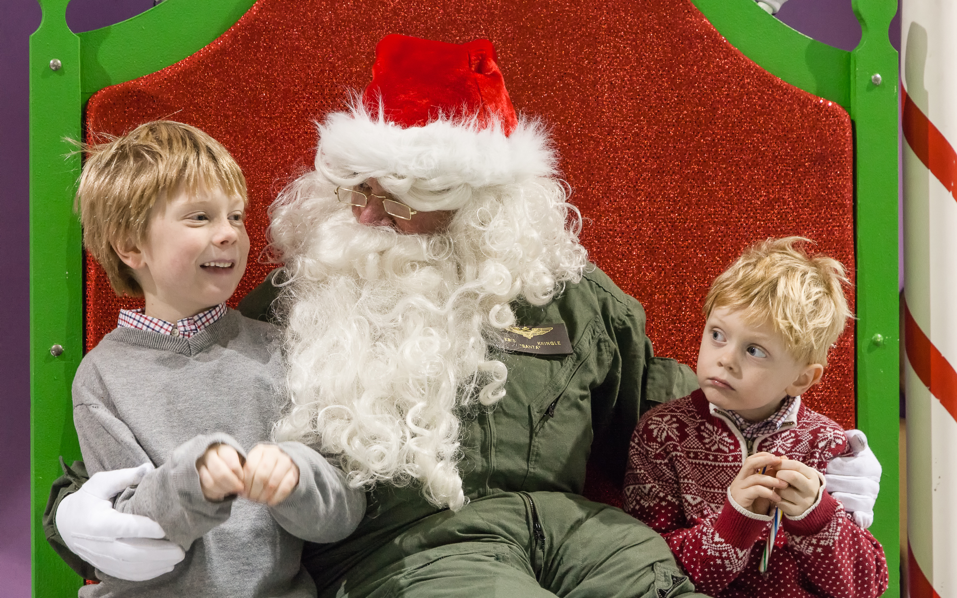 Two young boys meeting Santa in a flight suit