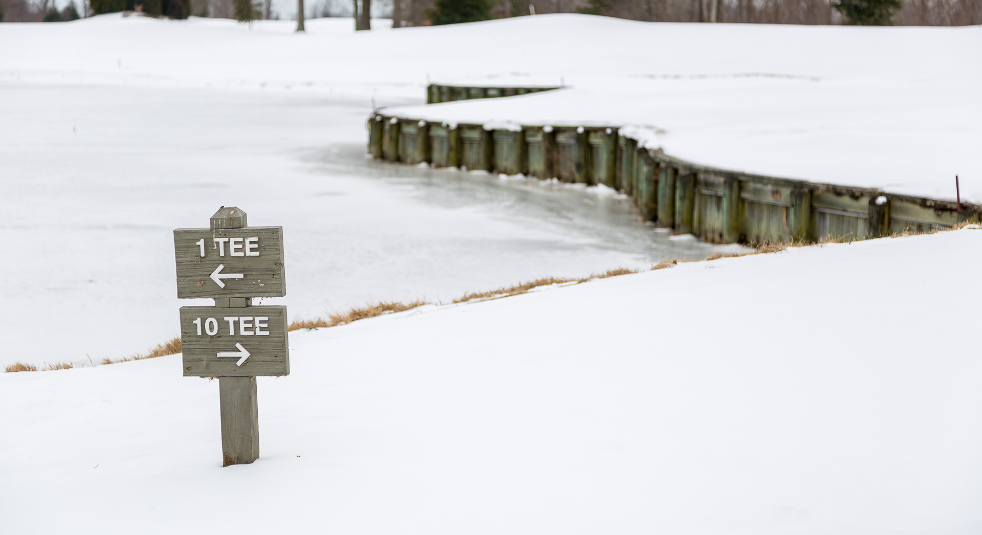 Shooting this snow photo of a sign at a golf course was taken with +2 exposure compensation to make the snow around it bright.