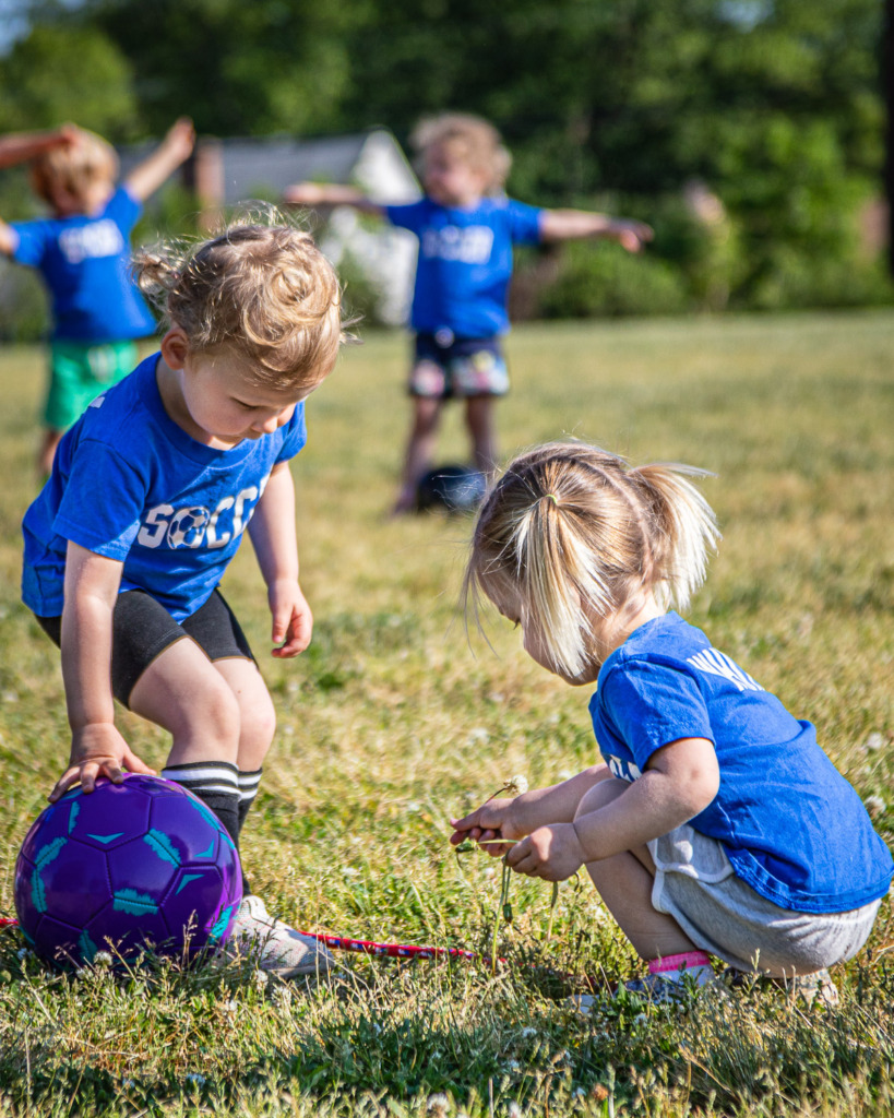 When you photograph childhood moments, you'll remember moments like this when your daughter stopped to pick dandelions in the middle of her soccer practice.