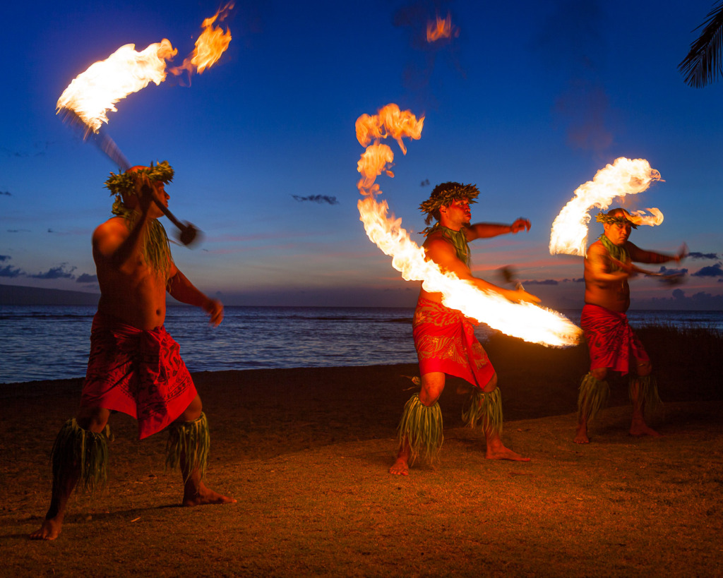 Manual Mode with a tripod allowed me to maintain a steady shot with a slower shutter speed so I could show the path of the flaming torches held by three fire dancers.