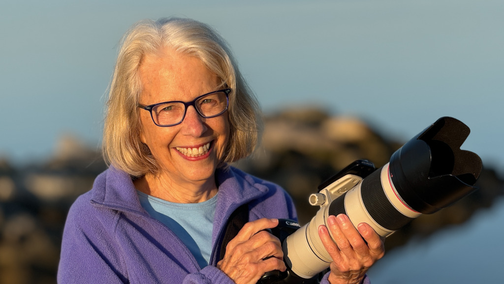 photo of woman with Canon camera and large lens and extender