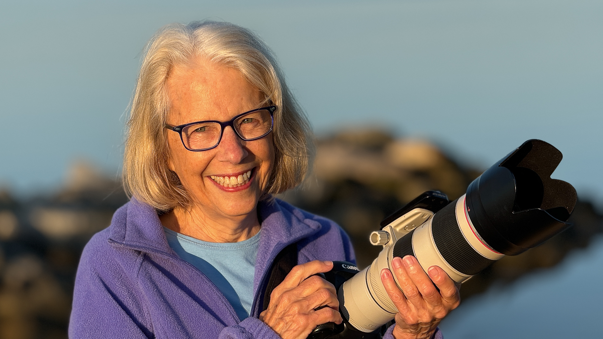 photo of woman with Canon camera and large lens and extender