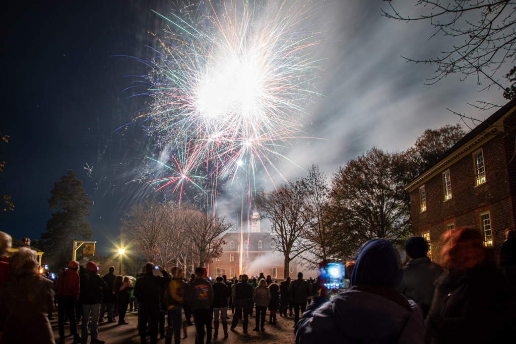 People photograph fireworks in the sky above the Capitol Building in Colonial Williamsburg, VA