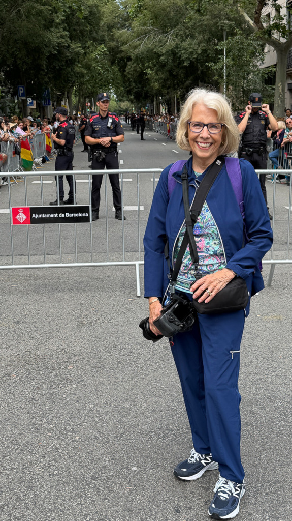 Caroline Maryan standing on street in Barcelona with many policemen behind her