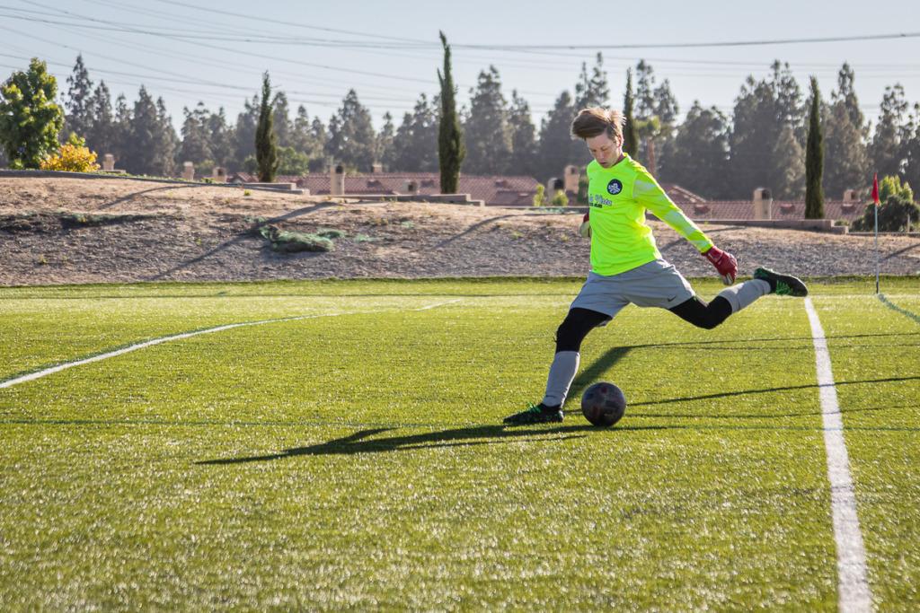 Capturing photos of moving kids like the teenaged soccer goalie kicking a ball can be a challenge